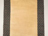 a brown and green rug with a square design on it