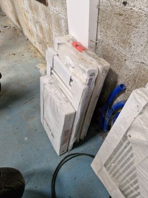 une pile de cartons posée par terre près d'un mur
