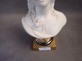 a white bust of a woman with a crown on it ' s head
