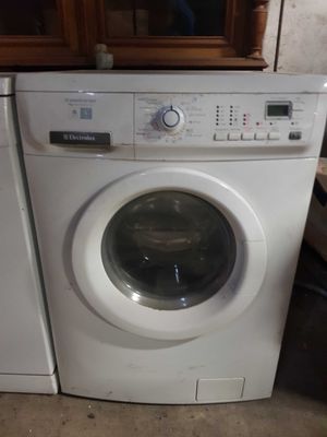 a washer and dryer sitting next to each other in a room
