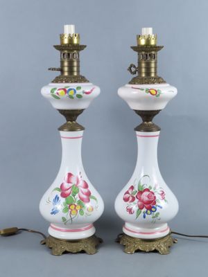 pair of white and gold vase lamps with floral designs on them