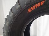 a close up of a tire on a white surface with a white curtain in the background