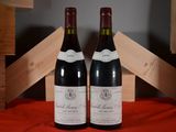 two bottles of wine sitting next to each other on a table