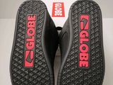 the soles of a pair of black shoes with red lettering on them