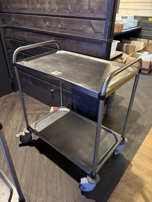 a metal cart that is on the floor in a room