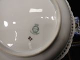 a white plate with a green and white design on it