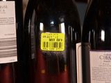 several bottles of wine on a shelf with a barcode on the label
