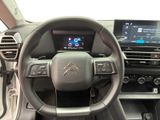 the interior of a car with a steering wheel, dashboard, and display screen