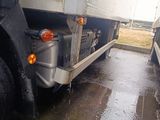 two large semi trucks parked side by side on the street