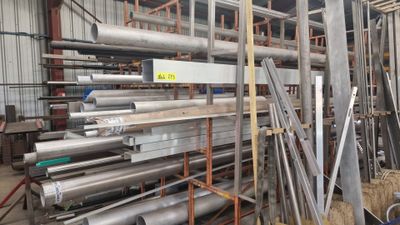 many metal pipes and pipes in a warehouse