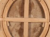 an old wooden box with a circular window on top of it
