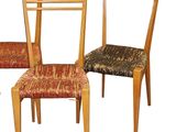 three wooden chairs with upholstered seats are lined up against a white background