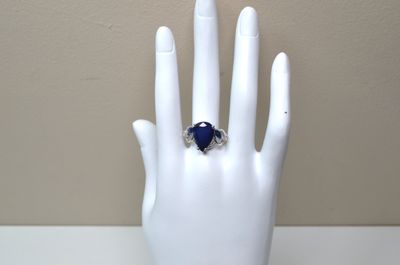 a hand with a ring on it that is sitting on a mannequin