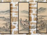 trois peintures asiatiques accrochées à un mur, à côté d'un mur de briques
