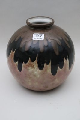 a black and brown vase with a tag on it