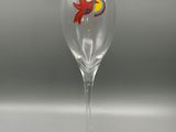 the wine glass has a bird painted on it