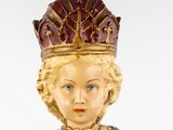 a figurine of a woman wearing a crown on her head