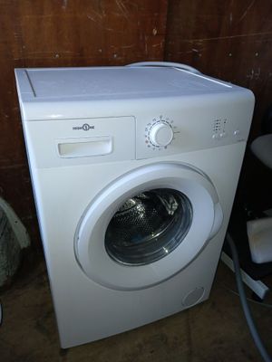 a washing machine that is sitting in the corner of a room