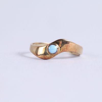 an image of a gold ring with a blue stone in the middle
