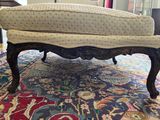 a couch that is sitting on a rug on the floor