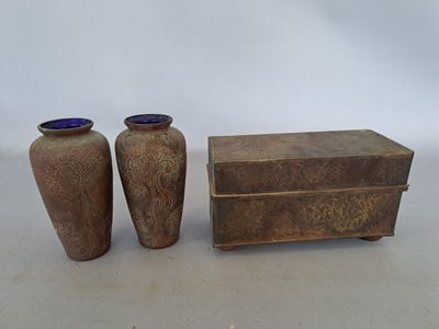 two vases sitting next to each other on a table