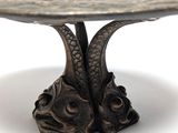 a metal table with two fish heads on it