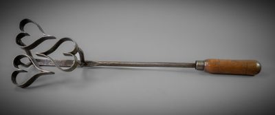 a large metal spoon with a wooden handle on a table