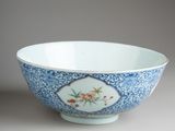 blue and white bowl with flowers and leaves on it