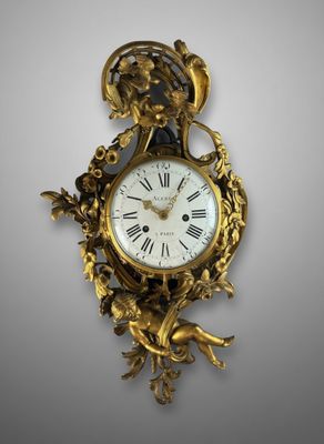 an antique clock with a bird on the back of it