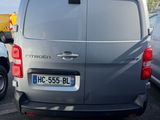 a silver van parked in a parking lot next to other cars