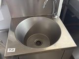 a stainless steel sink in a commercial kitchen