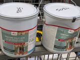 two buckets of paint sitting on a shelf