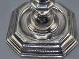 a silver candle holder on a table with a white background
