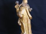 bronze statue of a woman holding a child on a pedestal