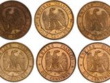 a close up of six different types of coins on a white background