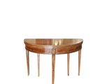an oval dining table with two legs and a wooden top