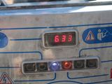 a close up of a machine with a clock on it