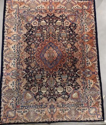 an antique persian rug with a medallion design
