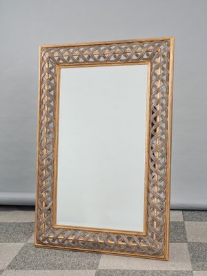 an image of a gold framed mirror sitting on a checkered floor