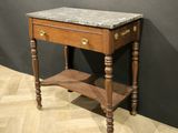 a small table with a marble top on a wooden floor