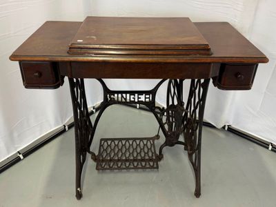 an old sewing machine sitting on a table in a room