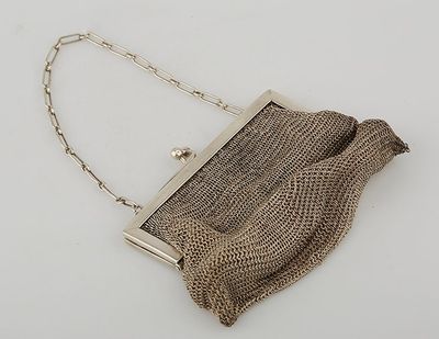 an antique silver mesh purse with chain strap and clasp