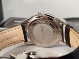 a close up of a watch with a leather band