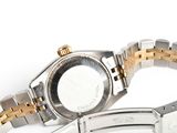a silver and gold wrist watch with a black face