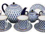 blue and white porcelain tea set with matching cups and saucers