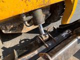 a close up of the front end of a yellow truck
