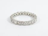 a close up of a diamond ring on a white surface
