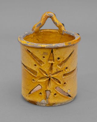 an image of a yellow vase with a star design on it