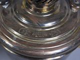 a close up of a silver plated lamp on a table