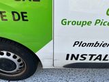 a green and white van parked on the side of the road